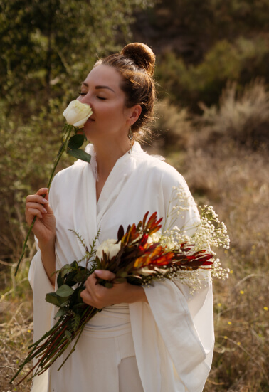 Girl walking in nature near Topanga Sound Labs Wellness center holding flowers