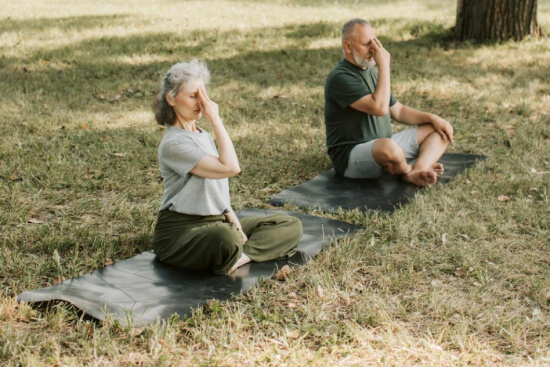 senior couple are doing outdoor meditation