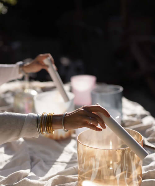 person playing golden sound healing instrument