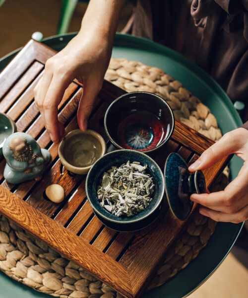 several cups on a wooden tray for tea ceremony