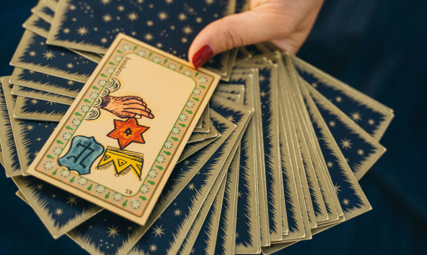 women hand holds playing cards for leela game