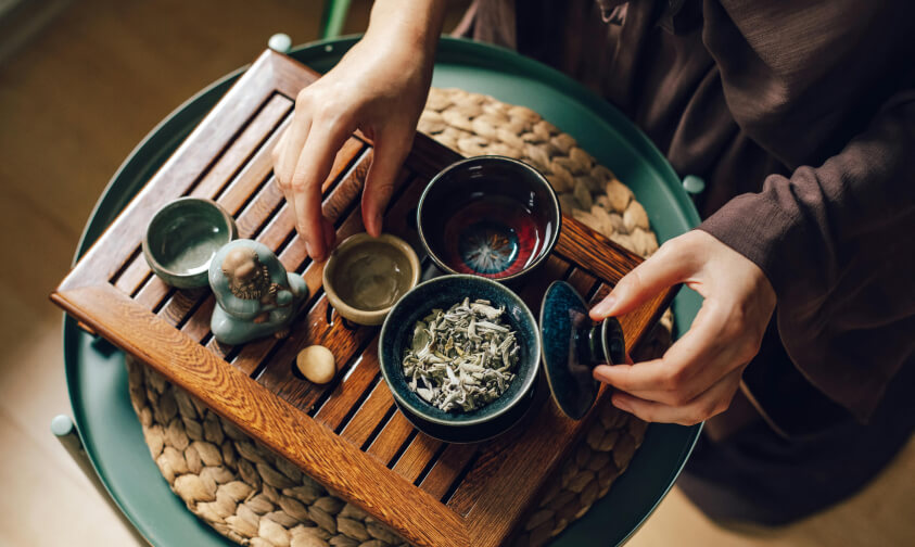 a set of ceremonial tea tools on a wooden try