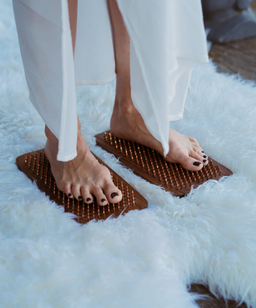 girls legs on a sadhu nail board