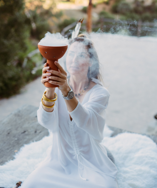 girl holding meditation lamp that produces smoke