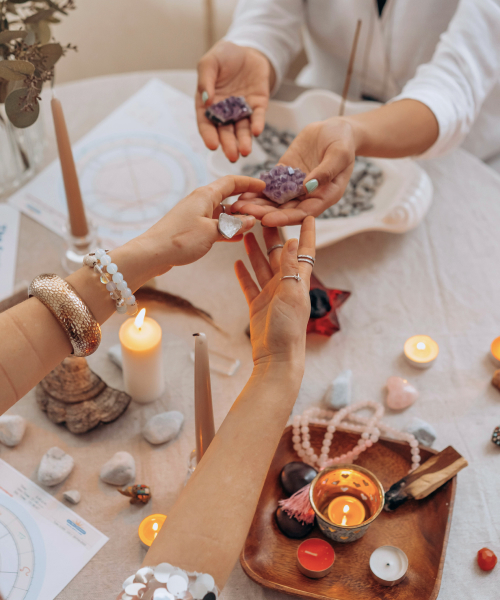 hands of two girls given spiritual crystals to each other