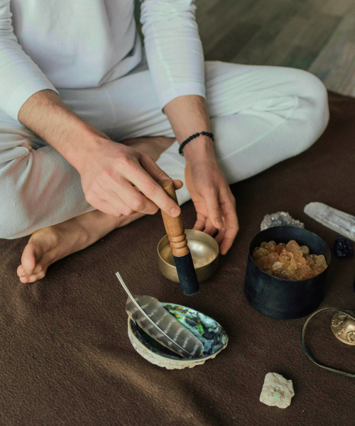 meditation tools, such as metal bowl, crystals and bird feather