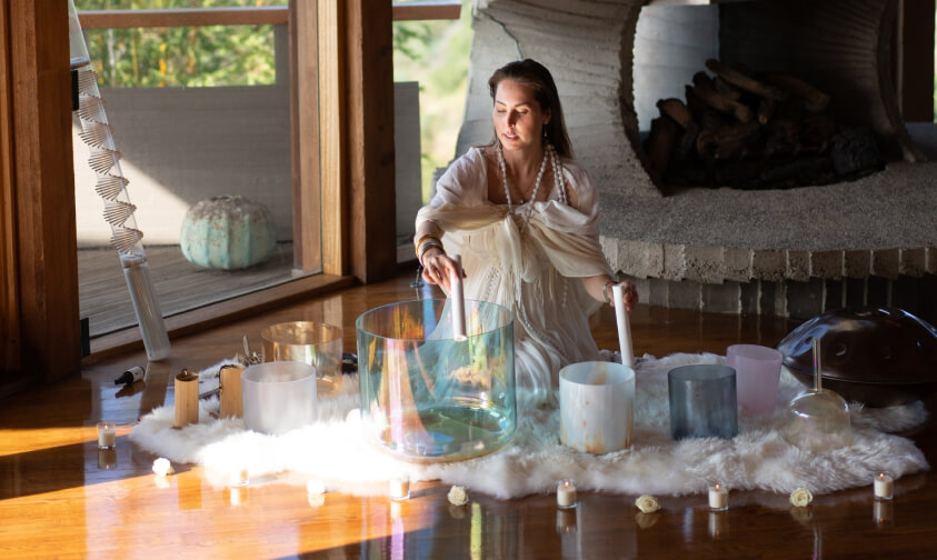 girl is playing sound healing instruments