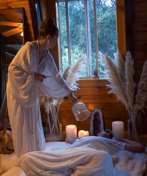 open window in a wooden room and a couple is doing sound healing meditation session